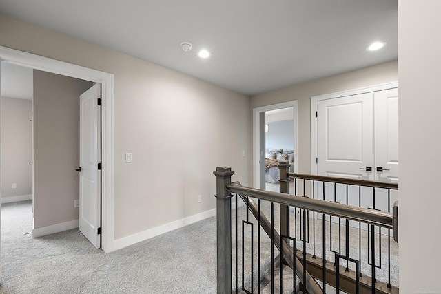 corridor with light colored carpet