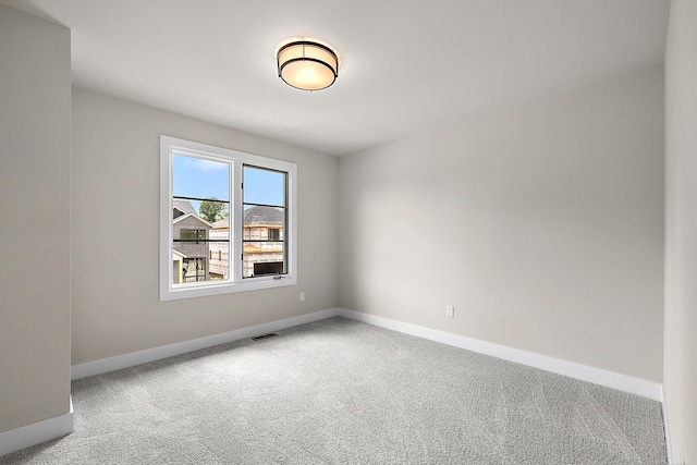 empty room featuring light carpet