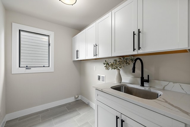 washroom featuring sink, cabinets, and washer hookup