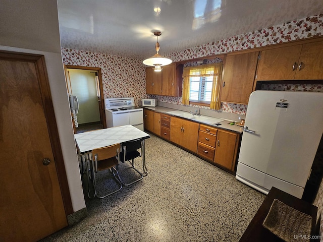 kitchen featuring sink, tasteful backsplash, tile countertops, pendant lighting, and white appliances