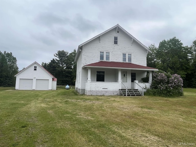 view of front of home with an outbuilding, a front yard, a porch, and a garage