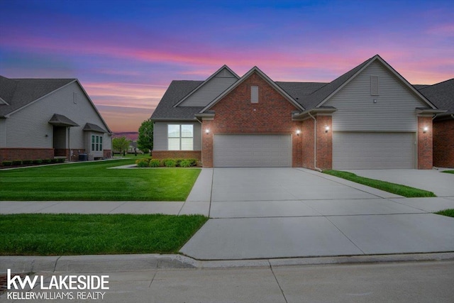 view of front of house featuring a garage and a yard