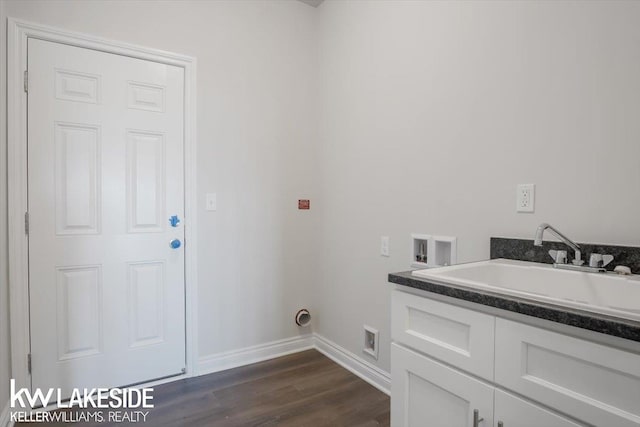 washroom with hookup for a washing machine, sink, dark wood-type flooring, and cabinets