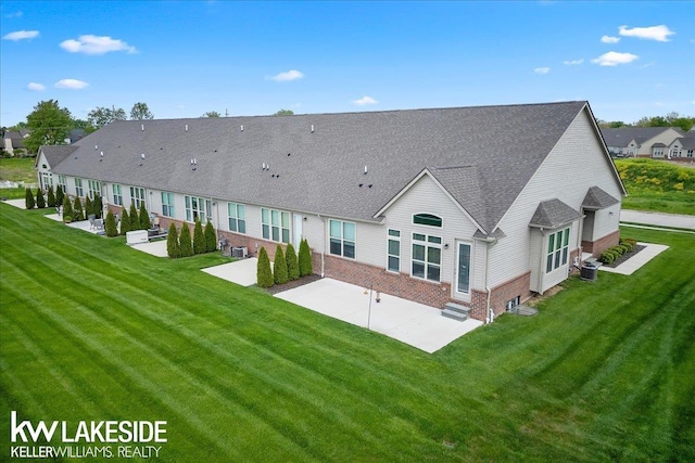 back of house featuring a patio, central air condition unit, and a lawn