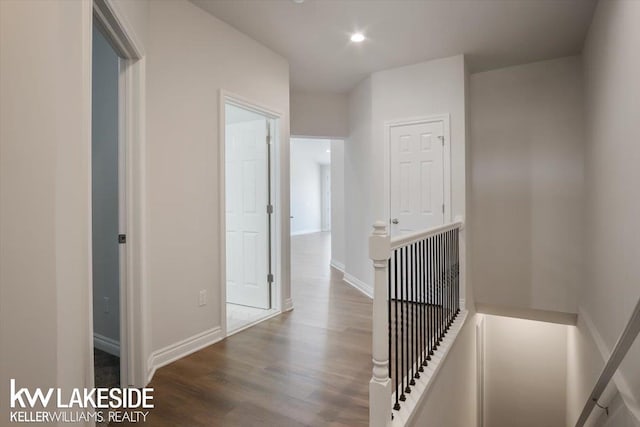 hall with hardwood / wood-style flooring