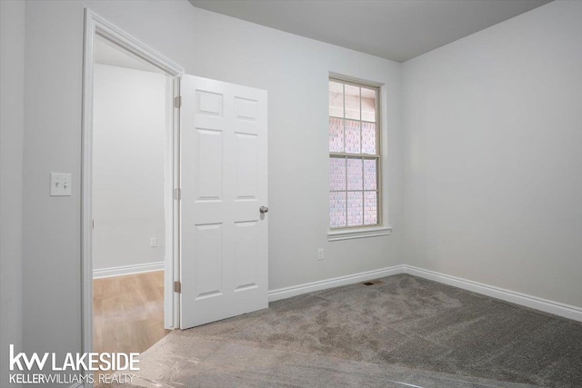 unfurnished room with light carpet