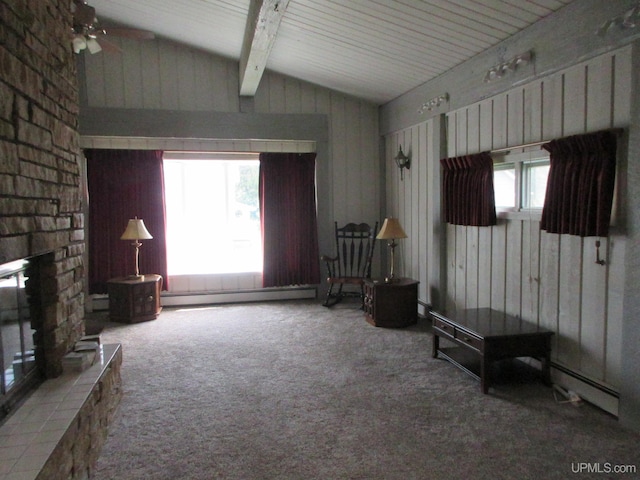 living room with ceiling fan, a baseboard radiator, lofted ceiling with beams, wood walls, and carpet floors