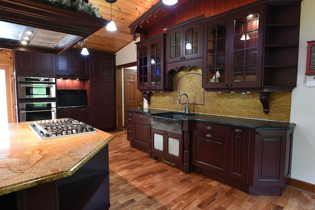 kitchen featuring sink, backsplash, hardwood / wood-style floors, and stainless steel appliances