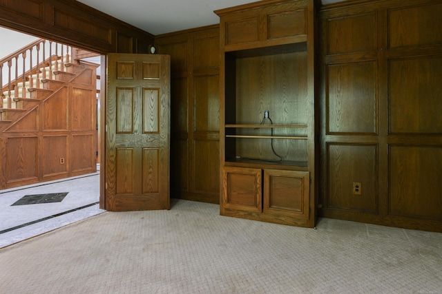 unfurnished living room with light colored carpet