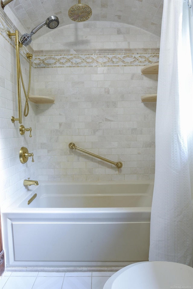 bathroom featuring tile flooring, shower / bath combination with curtain, and toilet