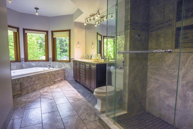 full bathroom featuring tile flooring, independent shower and bath, toilet, and vanity