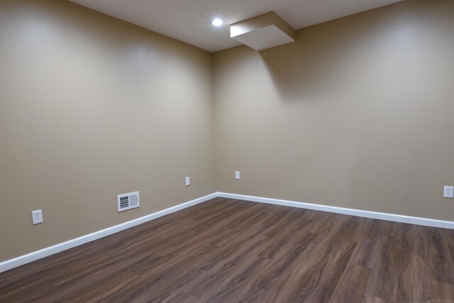 empty room with dark hardwood / wood-style floors