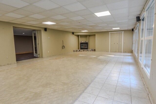 unfurnished room featuring light carpet and a drop ceiling