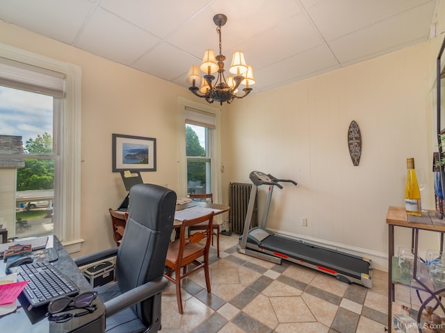 home office with radiator heating unit, a paneled ceiling, and a notable chandelier