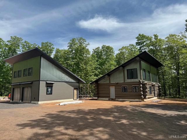 view of side of home featuring a garage and driveway