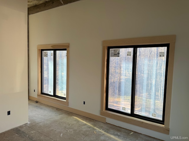 unfurnished room featuring beamed ceiling