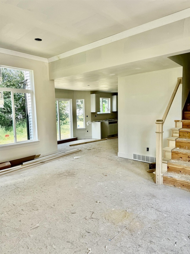 unfurnished living room featuring a wealth of natural light