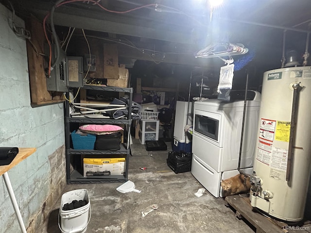 basement featuring water heater and washer / dryer