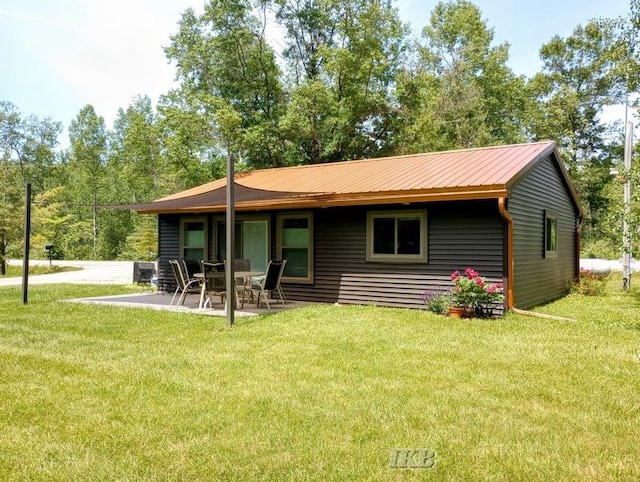 rear view of house with a yard and a patio