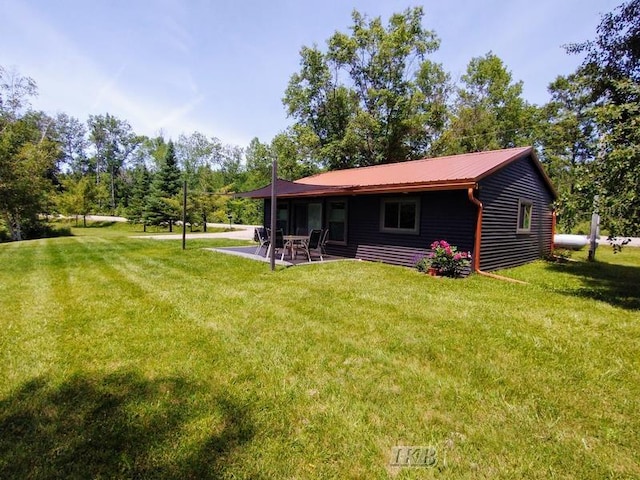 back of house featuring a patio area and a yard