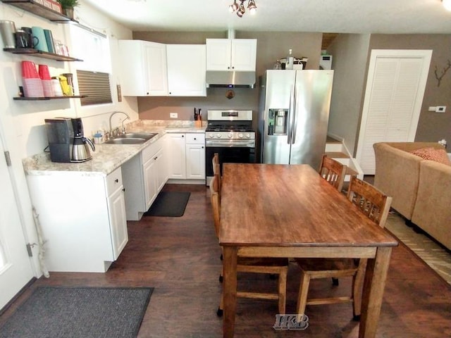 kitchen with dark hardwood / wood-style flooring, sink, white cabinets, and stainless steel appliances