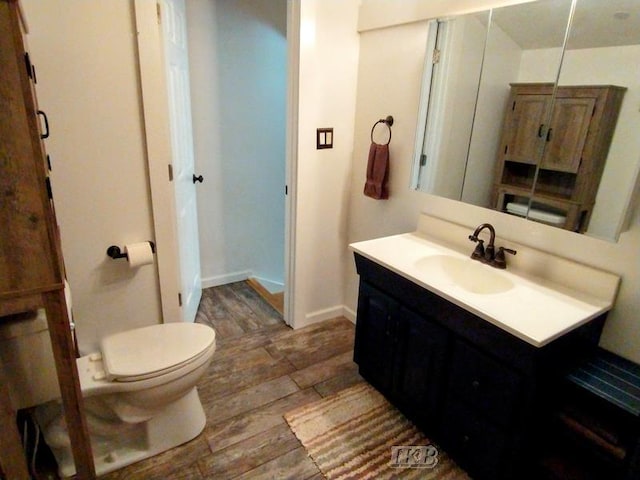 bathroom featuring hardwood / wood-style floors, vanity, and toilet