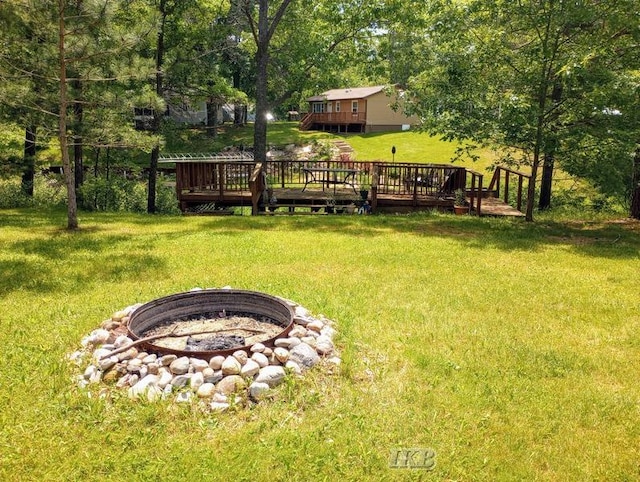 view of yard with a fire pit and a deck