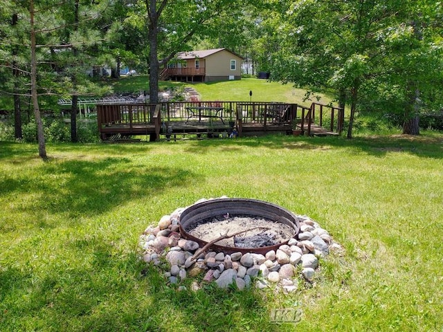 view of yard with an outdoor fire pit and a wooden deck