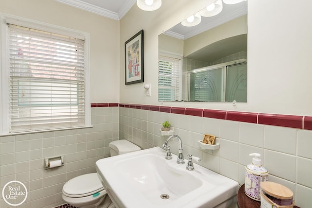 bathroom featuring tile walls, walk in shower, a healthy amount of sunlight, and sink