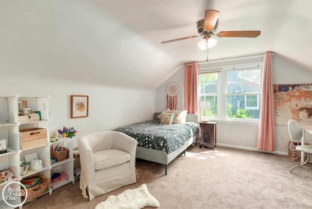 carpeted bedroom with ceiling fan and vaulted ceiling