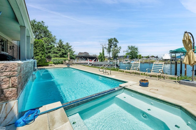 view of swimming pool with a patio and a water view