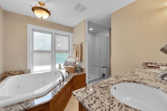 bathroom featuring vanity and independent shower and bath