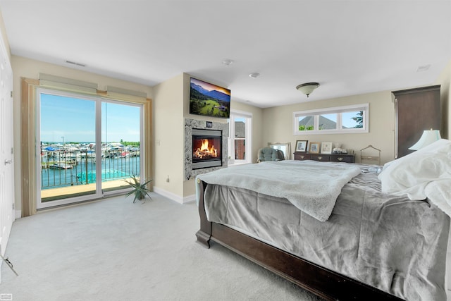 carpeted bedroom featuring access to exterior and multiple windows