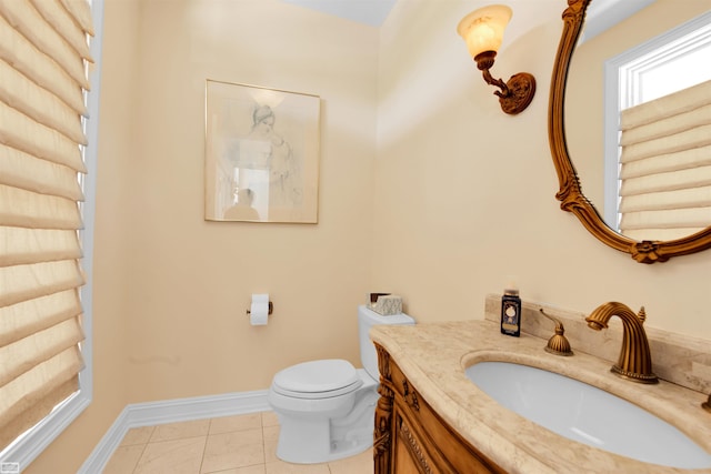 bathroom with tile patterned flooring, vanity, and toilet