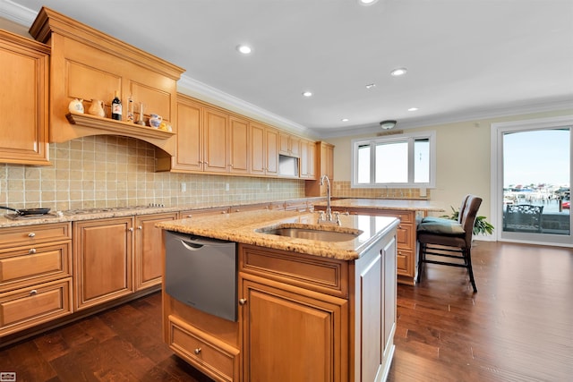 kitchen with appliances with stainless steel finishes, an island with sink, dark hardwood / wood-style floors, and sink