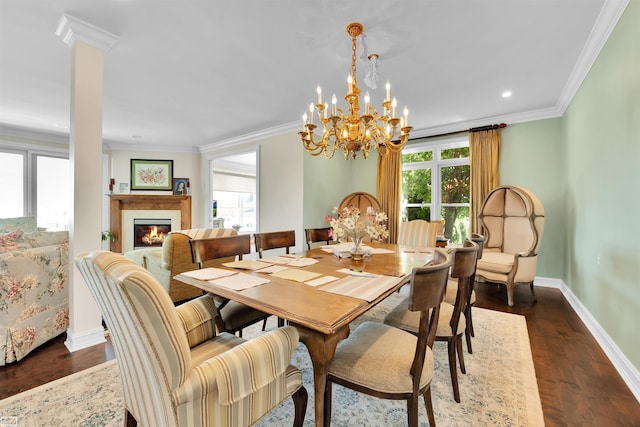 dining space featuring ornate columns, crown molding, dark hardwood / wood-style floors, and a notable chandelier