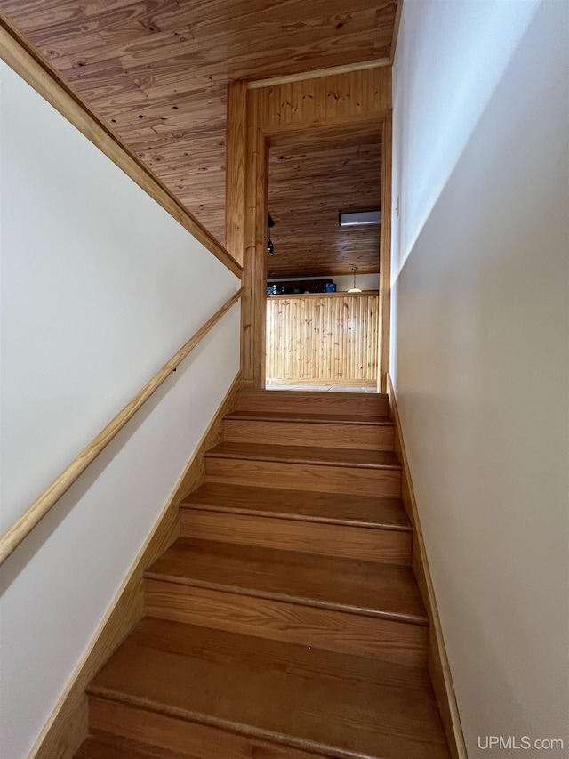 stairs featuring wooden ceiling