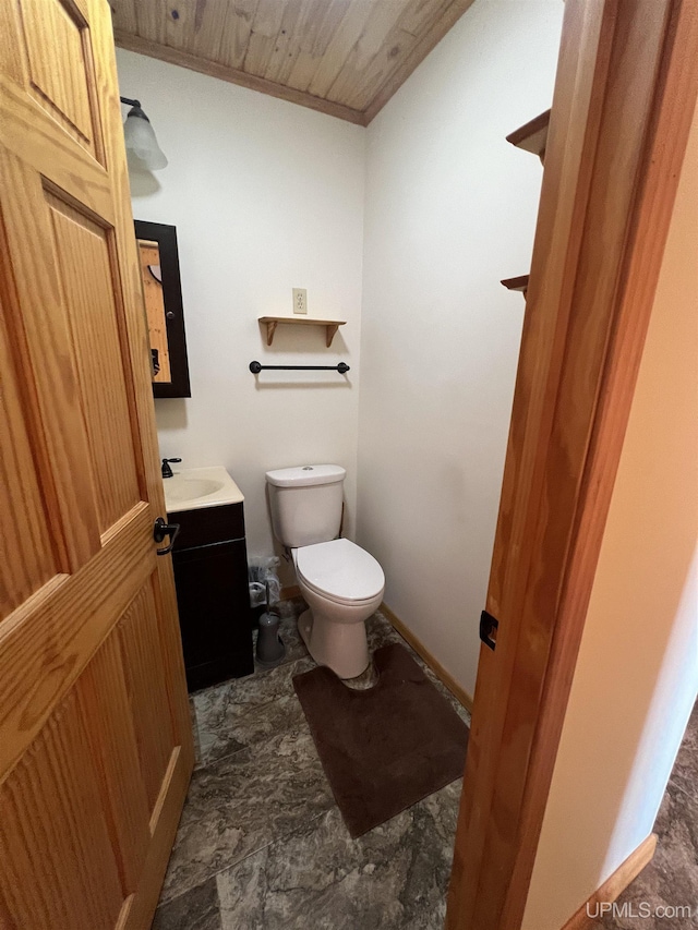 bathroom featuring vanity, wooden ceiling, crown molding, and toilet