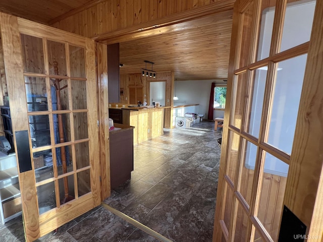 hallway with wood ceiling and wooden walls