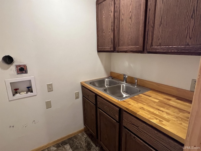 washroom featuring hookup for a washing machine, sink, hookup for an electric dryer, and cabinets