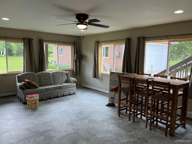 dining space with ceiling fan, ornamental molding, and a baseboard heating unit