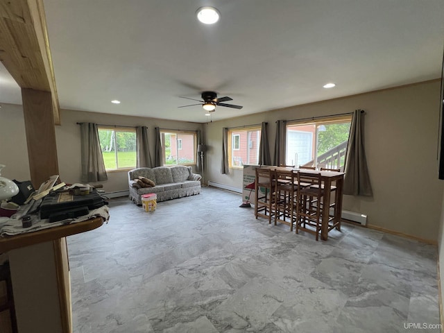 living room featuring a baseboard heating unit and ceiling fan