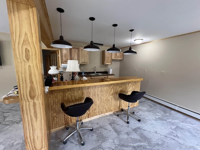 bar with light brown cabinetry, sink, hanging light fixtures, a baseboard radiator, and tile counters