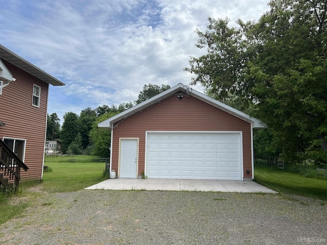 garage featuring a lawn