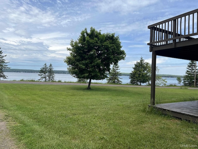 view of yard with a deck with water view