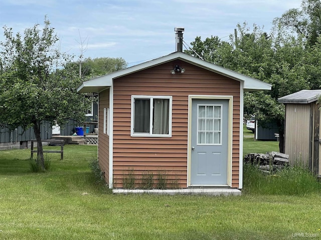 view of outdoor structure with a lawn