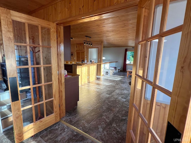 hallway with wood ceiling and wood walls