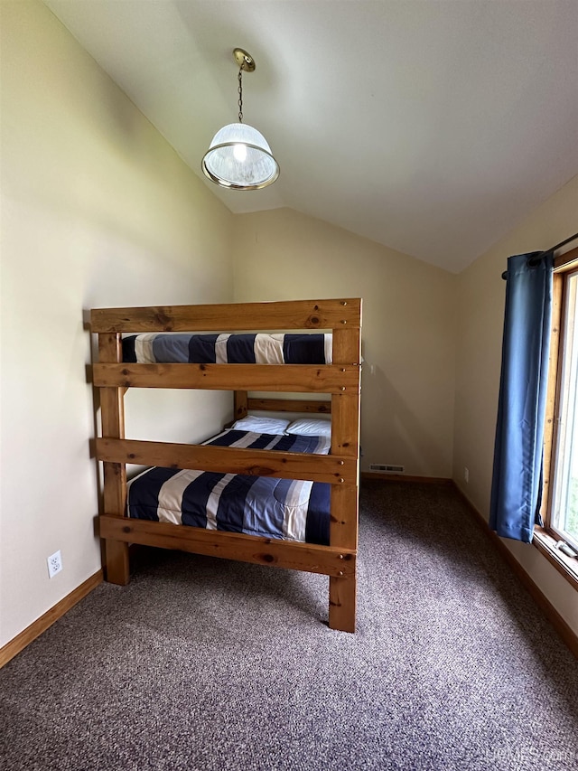 carpeted bedroom with vaulted ceiling