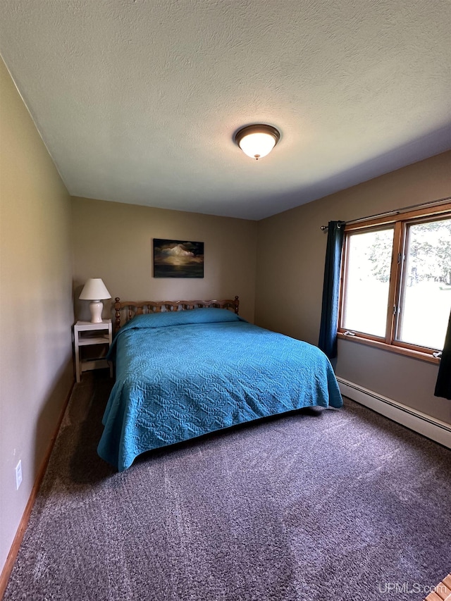 bedroom with a baseboard radiator, carpet flooring, and a textured ceiling