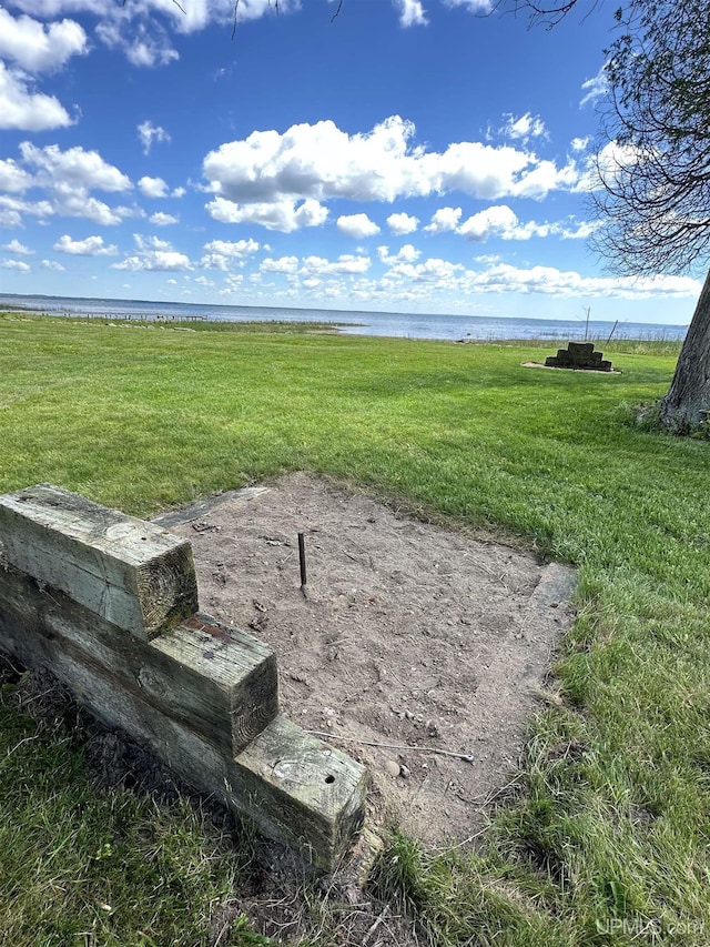 surrounding community featuring a water view and a yard